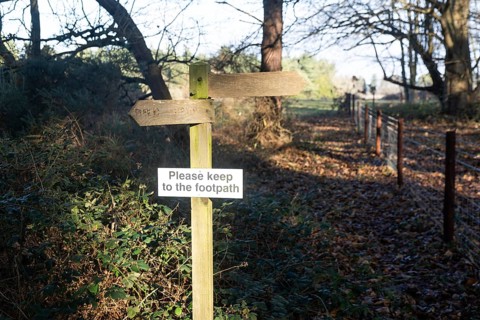 Please Keep To The Footpath wooden signpost in countryside, Sutton, Suffolk, England, UK