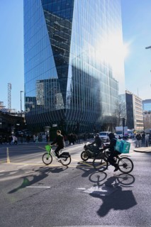 London, UK. January 31st 2025. A Lime bike and delivery rider cycle through a busy traffic