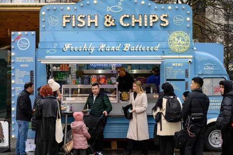 A blue retro Citroen food truck selling traditional British fish and chips on the south bank of the