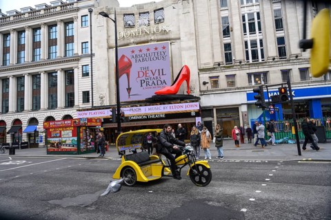 London, UK. January 30th 2025. A yellow tricycle passes the The Dominion Theatre showing The Devil