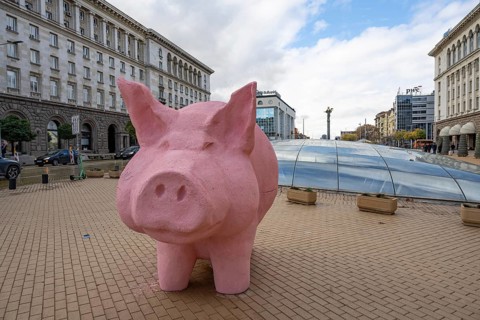 Sofia, Bulgaria. November 23rd 2025. A mock pink piggy bank instillation as a visual protest