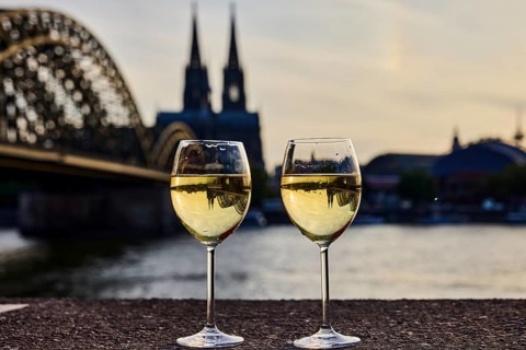 Wine glasses, wine, light refraction in filled glasses, concrete wall, Rhine river, Hohenzollern