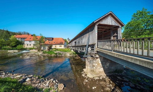 Covered wooden bridge from 1818 and historic water mill on the Ilm river, Buchfart, Weimarer Land,
