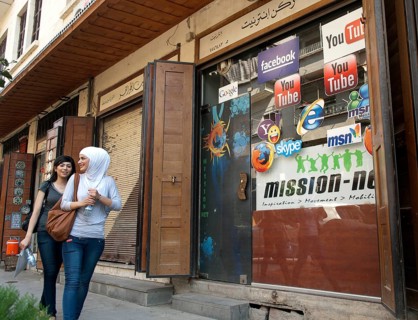 Damascus, Syria. 18th September 2011 Two Syrian girls walking past an internet cafe on the Street