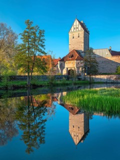 View across the Rothenburg pond to the historic old town with city wall and Rothenburg Gate,