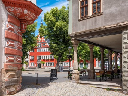 Houses and arcades on the market square in the historic old town, in the back the town hall,