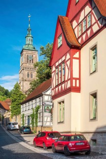 Street with half-timbered houses and cobblestones at the Gothic St. Mary's Church, Königsberg in