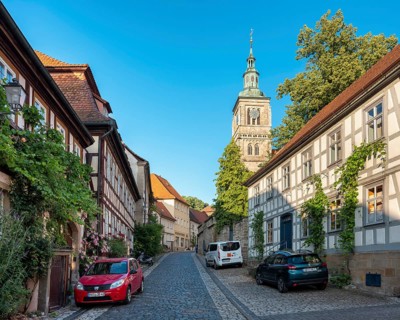 Street with half-timbered houses and cobblestones at the Gothic St. Mary's Church, Königsberg in