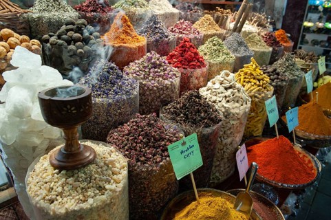 Dubai, United Arab Emirates. July 1st 2019 Incense burning alongside coloured spices for sale in