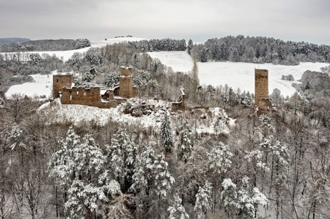 Old castle ruins in a snowy, wooded winter landscape, The Brandenburg in the Werra Valley near