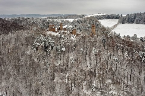 Wide view of a ruin in a wintry forest with snow-covered hills, The Brandenburg in the Werra Valley