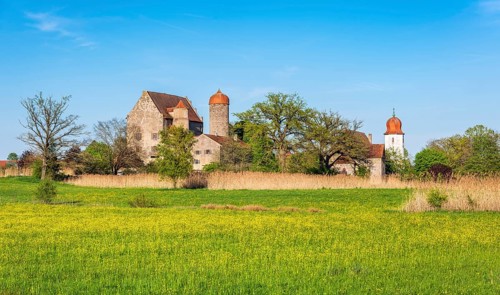 View over wildflower meadow at Sommersdorf Castle near Burgoberbach in the Altmühltal, Middle