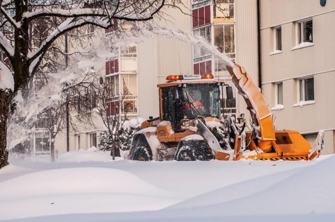 Snow blower clears snow on street in Ystad, Skåne County, Sweden, Scandinavia