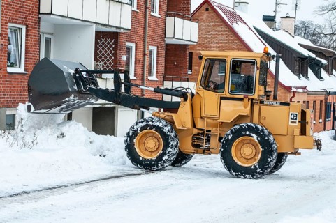 Loader clearing snow on streets in Ystad, Skåne County, Sweden, Scandinavia