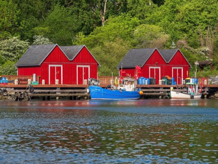 Small red huts and fishing boats in Boltenhagen fishing port, Baltic resort Boltenhagen,