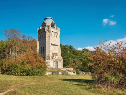 The Bismarck Tower at Großer Fallstein in autumn under a blue sky with fair weather clouds,