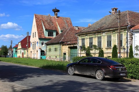 Typical rural houses in the old village of Dealu Frumos, Schönberg, in front of that an Opel