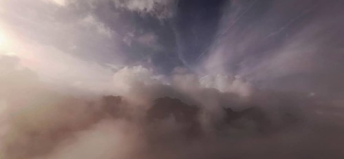 Gentle fog and cloud formations over a mountain landscape at dusk, hiking in the High Tatras