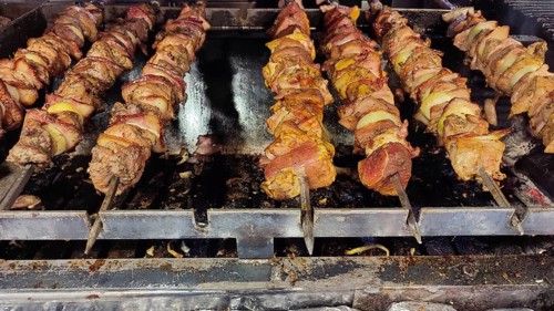 Close-up of grilled meat skewers, shish kebab over a hot grill, Zakopane, hiking in the High Tatras