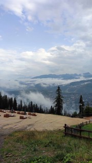 Panoramic view from a viewpoint on Mount Gubalowka with clouds, mountains and a town in the valley,