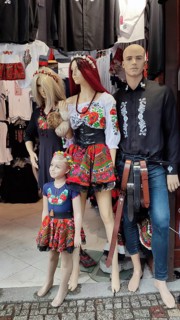 Three dolls in traditional, folkloric clothing with floral patterns in a shop window, Zakopane,