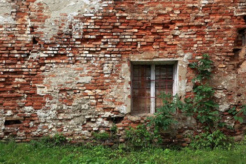 Dilapidated house wall with window, built with brick, Transylvania, Romania