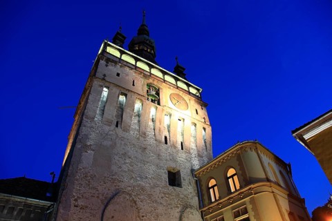 Romania, hour tower at the blue hour in the historic old town of Sighisoara, German Sighisoara,