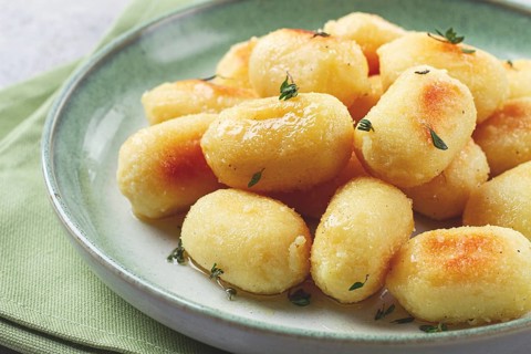 Stuffed gnocchi with cheese, Italian dumplings, garnished with parmesan cheese, no people