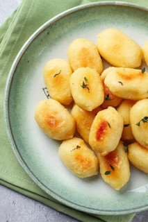 Stuffed gnocchi with cheese, Italian dumplings, garnished with parmesan cheese, no people