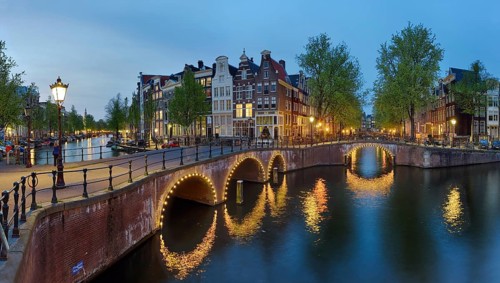 Canals illuminated panoramic night Amsterdam Netherlands