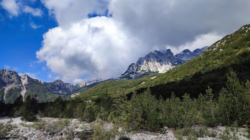 Majestic mountains with eye-catching cloud formations over dense forest, Peaks of the Balkans,