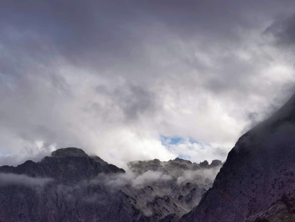 Dark, dramatic clouds over jagged mountain peaks creating a majestic scene, Peaks of the Balkans,
