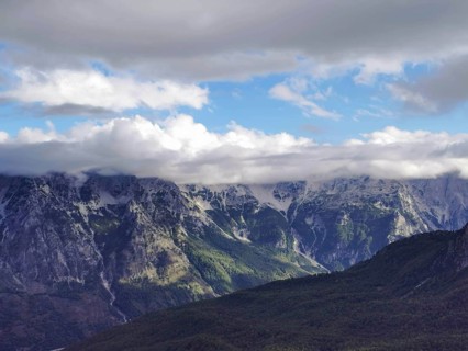 Fascinating mountain landscape with clouds floating over the peaks and light play in the sky, Peaks