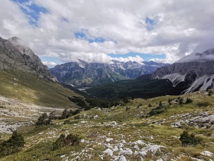 View of magnificent mountain landscape with a winding valley and clouds, Peaks of the Balkans,