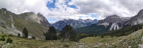 Extensive mountain panorama with forests between rocky peaks and clouds, Peaks of the Balkans,
