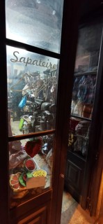Shoemaker's shop window with traditional tools and materials at night, Lisbon