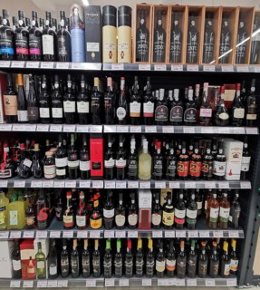 Shelf full of various port wines, wine bottles and spirits in a shop, Lagos, Algarve, Portugal