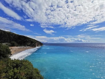 Panoramic view of a beach with turquoise sea and spectacular cloud patterns, Gjipe Beach, Albania