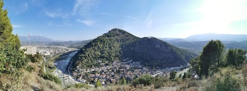 Panoramic view of Berat, of wooded hills, valley with river under clear sky, Berat, Albania