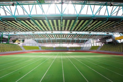 Extensive sports hall with green running track, surrounded by large windows, Sindelfingen Glass