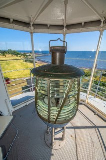 The lens of Smygehuk lighthouse and view towards Smygehamn in Trelleborg municipality, Baltic Sea,
