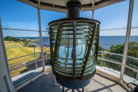 The lens of Smygehuk lighthouse and view towards Smygehamn in Trelleborg municipality, Baltic Sea,