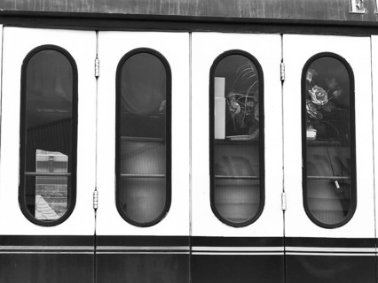 Monochrome photo of the windows of a nostalgic wagon on a steam locomotive, Rosen, Germany