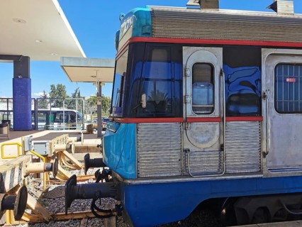 A blue train stands in the station area in bright sunshine, Lagos, Algarve, Portugal