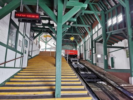 Large mountain station in wooden design with yellow stairs leads to the cable car, Oberweissbach