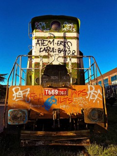 Graffiti painting, colorful locomotive at sunset, Albania