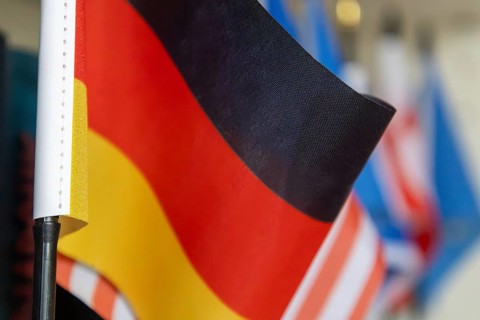 Close-up of a German flag in front of other flags (USA, Europe etc.)
