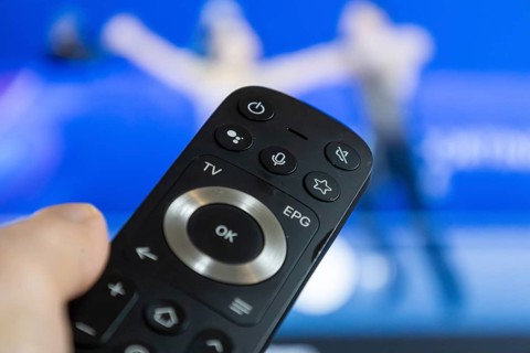 Close-up of a remote control during a broadcast of the Olympic Games in Milan/Cortina