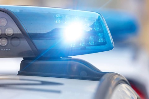 Symbolic image police operation: close-up of a blue light on a police car (digitally reworked)