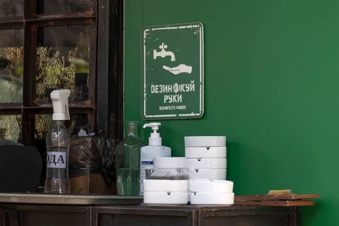 Information sign for hand disinfection in a garden restaurant, Lviv, Ukraine